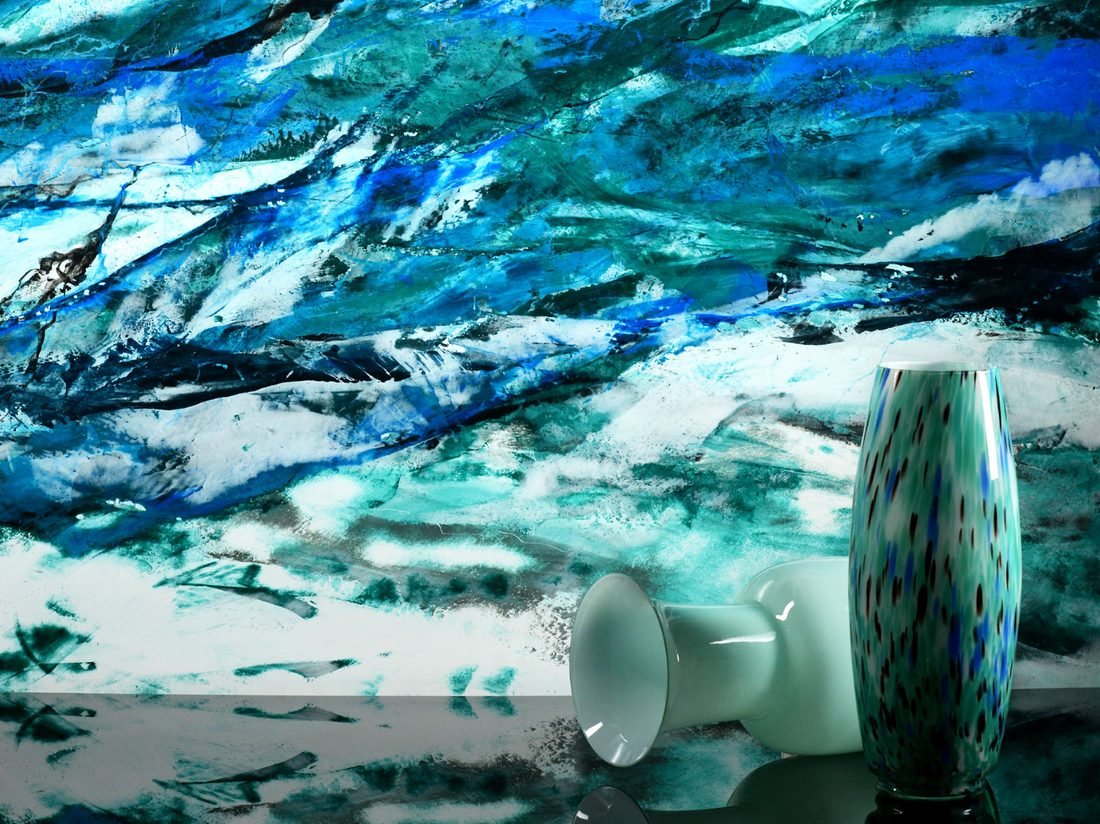 Mirror Plus finish in a dramatic wave-like blue and teal marbled pattern, styled with glass vases
