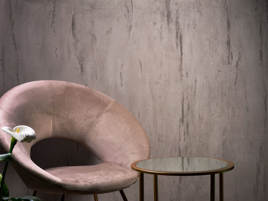 Travertino Toscano finish on a grey striped wall, styled with a pink accent chair and mirrored side table